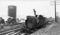 This photograph of the wreckage of tanker cars at Volland, Kansas was probably taken the day after the crash and fire. Notice the railroad wrecker working in the center of the photo.