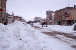 This Charles Herman view of snow removal from Alma's downtown business district looks to the south from the Alma Hotel.