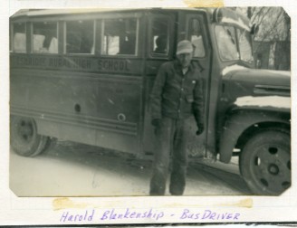 Eskridge Rural High School bus driver, Harold Blankenship stands beside his bus on a snowy day at Eskridge.